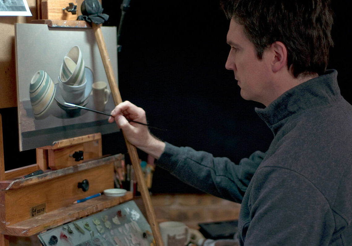 David Jamieson painting at the easel.