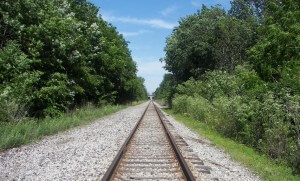 Rail road tracks seen in one-point perspective where the convergence effect is clearly visible.