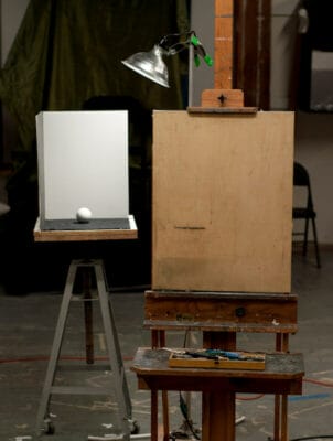 Sphere, light and shadow box configuration at the studio, with easel and drawing board.