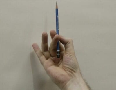 Hold the pencil between the thumb and index finger, with the middle finger helping to stabilize. The ring finger and pinkie finger float free.