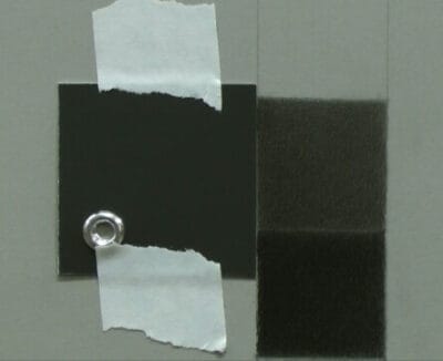 A Munsell neutral value chip taped to the page for the value scale exercise.